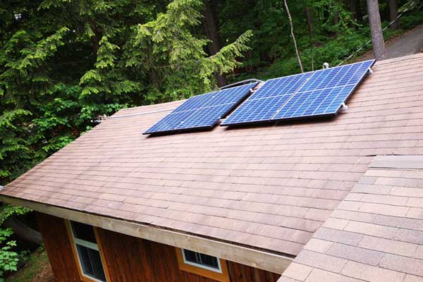 installation of Microgreen solar panels on cottage roof