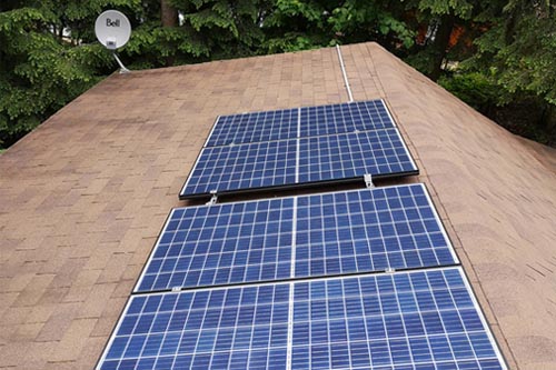 installation of Microgreen solar panels on cottage roof