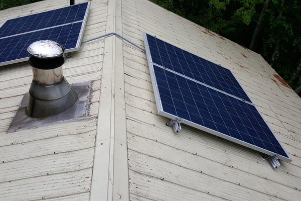 installation of Microgreen solar panels on cottage roof